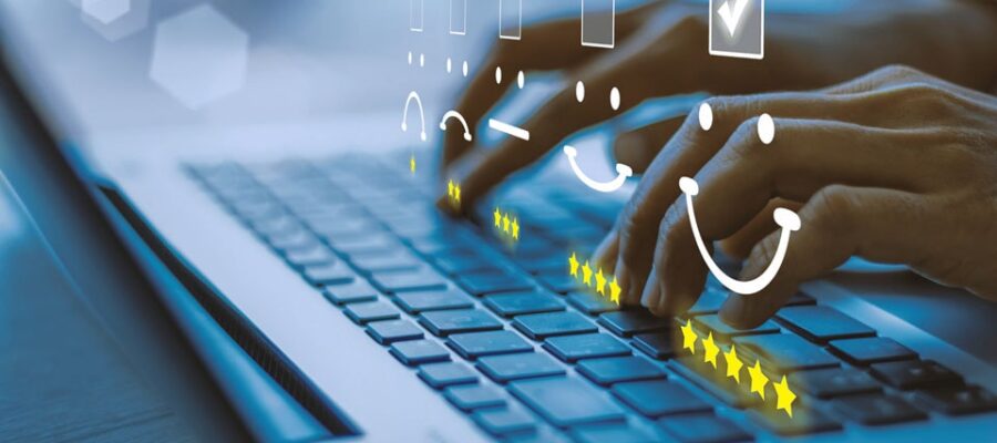 Customer focus Cover image – Hands typing on a laptop keyboard with digital smileys and star ratings as symbols of customer satisfaction.