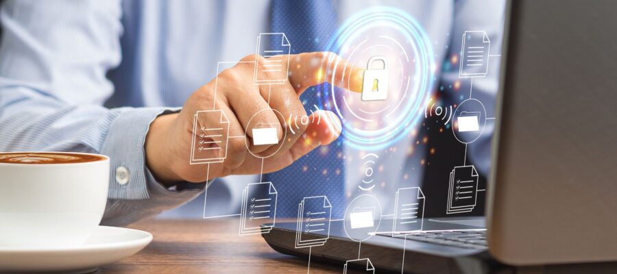 Privileged Access Management Cover Image. A person taps on a digital lock icon above a laptop to control secure access to files.